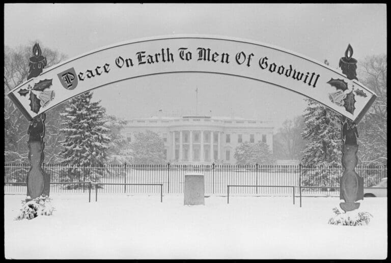 White House in the snow with sign reading “Peace on Earth to Men of Goodwill”